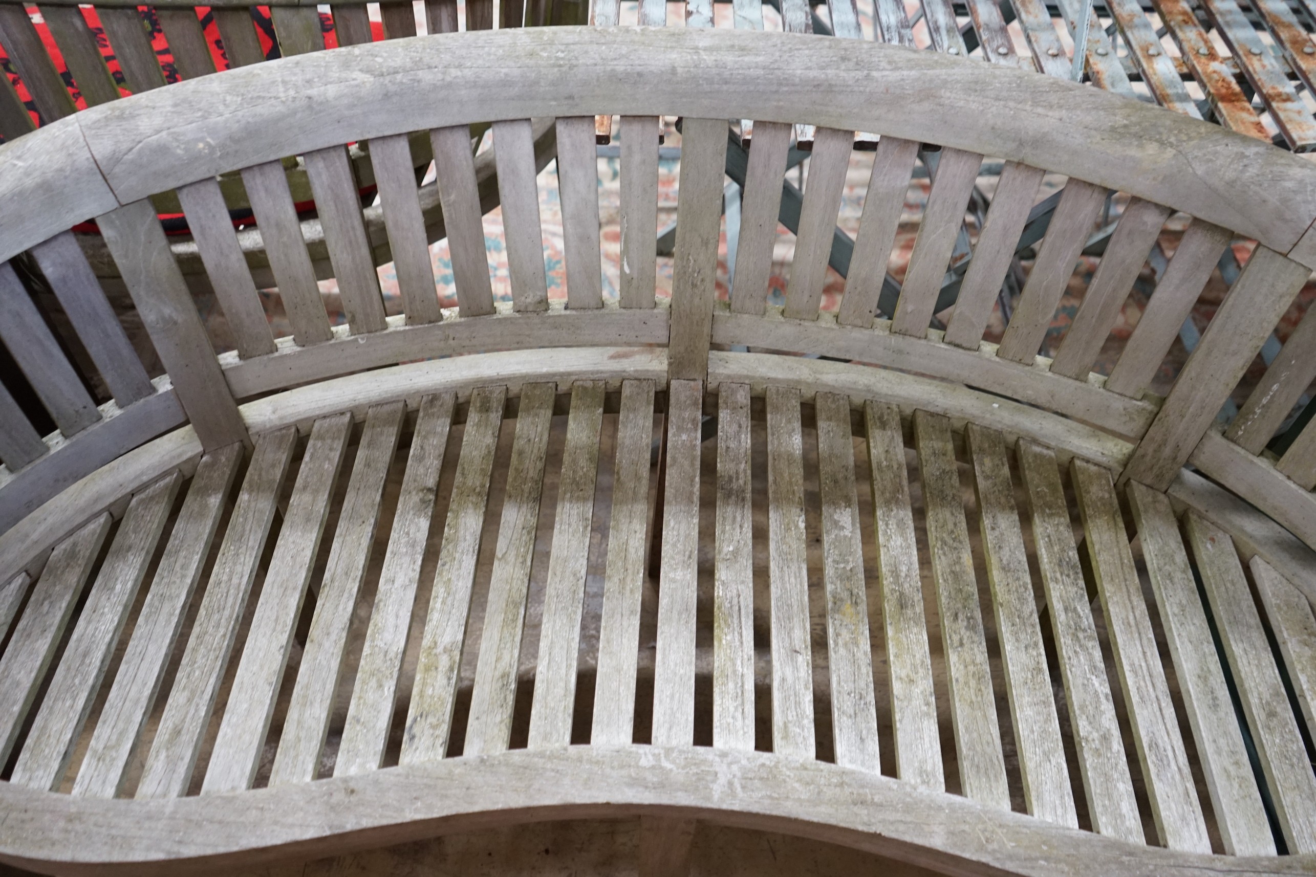 A weathered teak garden banana bench, length 160cm, height 84cm